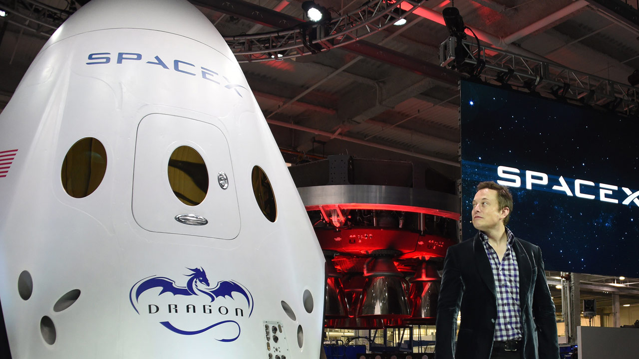 elon musk in front of a tesla motor vehicle